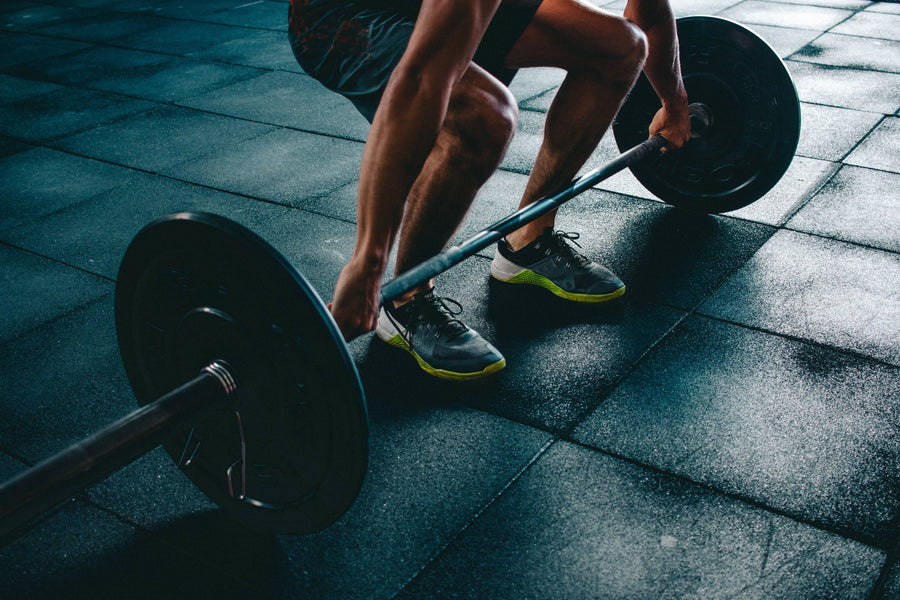 man lifting weights in gym