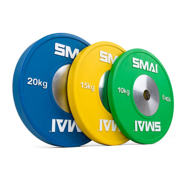 Three weight plates from the "SMAI Competition Bumper Plate Set with Barbell - 90kg" are displayed standing upright in a row. From left to right, they are colored blue (20 kg), yellow (15 kg), and green (10 kg). These plates provide an ideal solution for Olympic weightlifting enthusiasts looking for top performance.