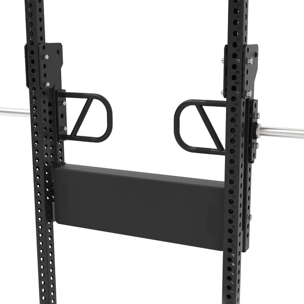 A close-up of the SMAI Leg Press Attachment - Vanta Series, showing its black adjustable safety arm and spotter platform with multiple height options—ideal for customizing your home gym power rack; a barbell is partially visible in the background.