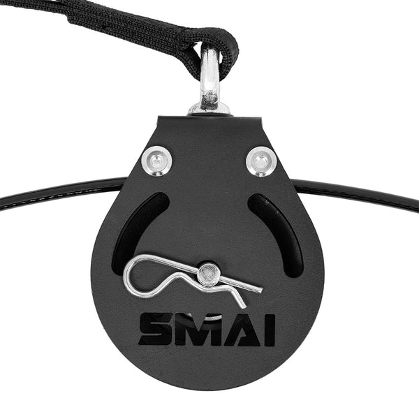 A close-up of the SMAI Cable Pulley System shows a black pulley with a metal safety pin and "SMAI" cut out on the front, attached to straps and cables—ideal for functional strength training in your home gym.