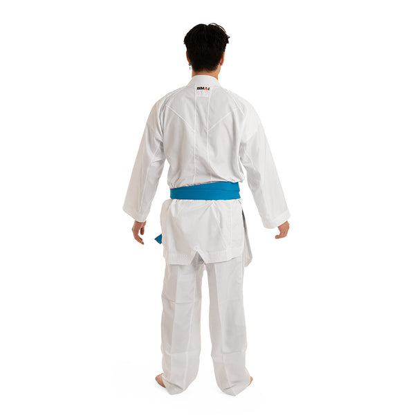 A person in a white WKF Reversible Karate Uniform by SMAI, featuring the 6oz Premium Kumite Gi of the Inazuma RX series and a blue belt, stands facing away against a white background to showcase the reversible jacket.