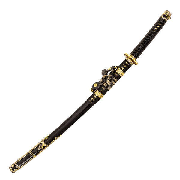 The SMAI Forged Carbon Steel Katana - Dark Emperor features a black full tang blade with ornate gold detailing and intricate patterns on the handle, guard, and scabbard, plus a decorative cord tied near the top.