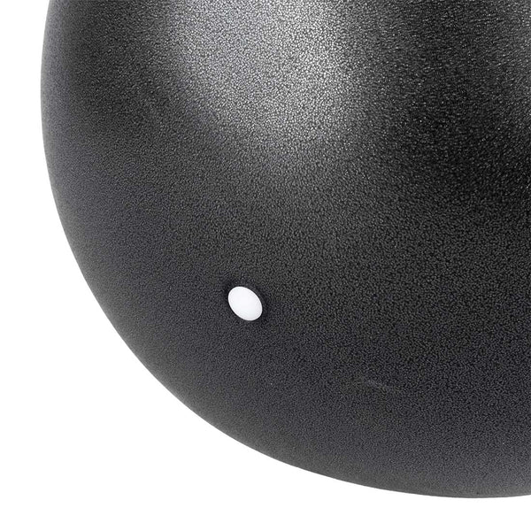 Close-up image of the Pilates Ball by SMAI, showcasing its textured black surface with a small white circular dot, epitomizing the simplicity and precision found in core-strengthening exercises.