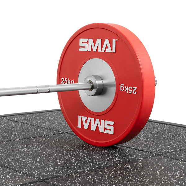 A barbell with red 25kg weights sits safely on a 50mm speckled gym floor, enhanced by the "Weight Lifting Platform - Acoustic Rubber White Fleck" for impact protection. The plates proudly display "SMAI" in crisp white letters.