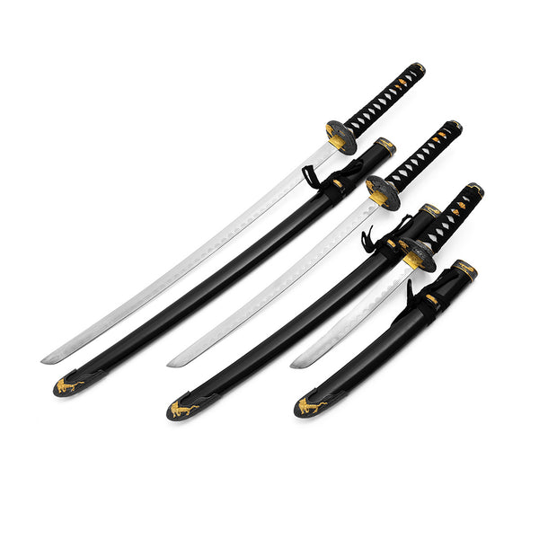The SMAI Daisho - Carbon 3pc Set with Stand - Shi no Tora features three collectible samurai swords with black and gold handles, matching scabbards, and ornate gold detailing for a striking display.