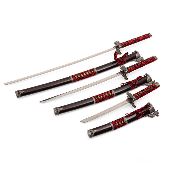 The Daisho - 3pc Set with Stand - Molten Dragon by SMAI features three Japanese swords with red and black wrapped handles, ornate guards, and matching black scabbards accented in red and gold, displayed diagonally on a white background.