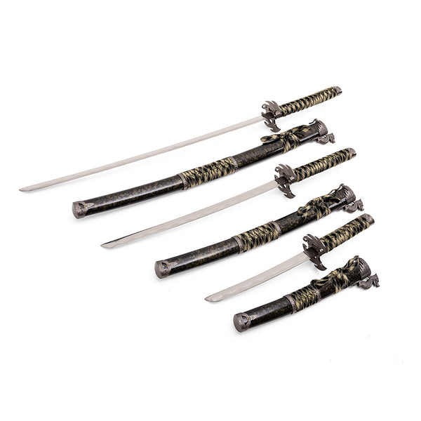 The SMAI Daisho - 3pc Set with Stand - Desert Dragon features three traditional Japanese swords with coordinated black and gold-wrapped handles and ornate sheaths, elegantly displayed together.