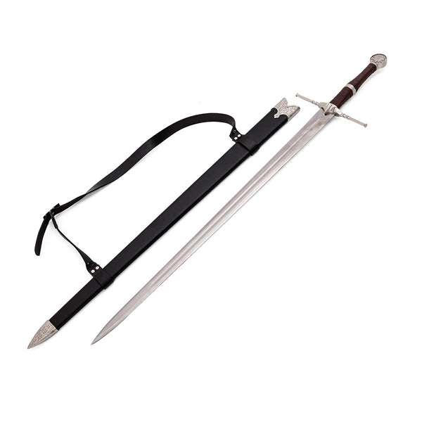 The SMAI Medieval Sword - Witch Hunter Deluxe features a brown and silver handle, ornate pommel, and cross-guard, displayed with a black leather scabbard with shoulder strap and silver detailing—ideal for display.