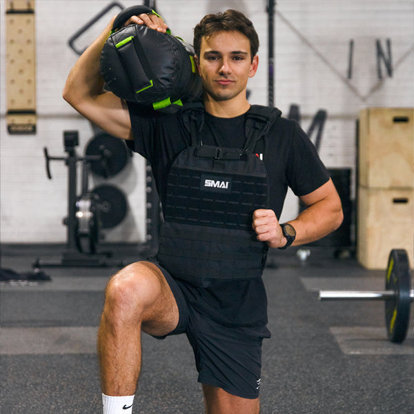 Man lunging with core bag on his shoulder wearing the SMAI weight vest adjustable black