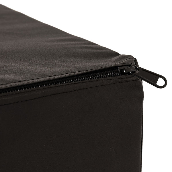 A close-up view of the SMAI Plyometric Box - Foam Covered - Black Series highlights a partially open zipper on its black fabric cover, revealing detailed stitching at the corner. Set against a plain background, the image focuses on the high-quality zipper and durable fabric texture—showcasing the robust construction and superior finish expected from essential training equipment by SMAI, specifically designed for box jumps.