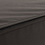Close-up of a black zipper running along the edge of a dark fabric surface with visible stitching, as seen on the SMAI Plyometric Box - Foam Covered - Black Series, designed for safe and durable box jumps.