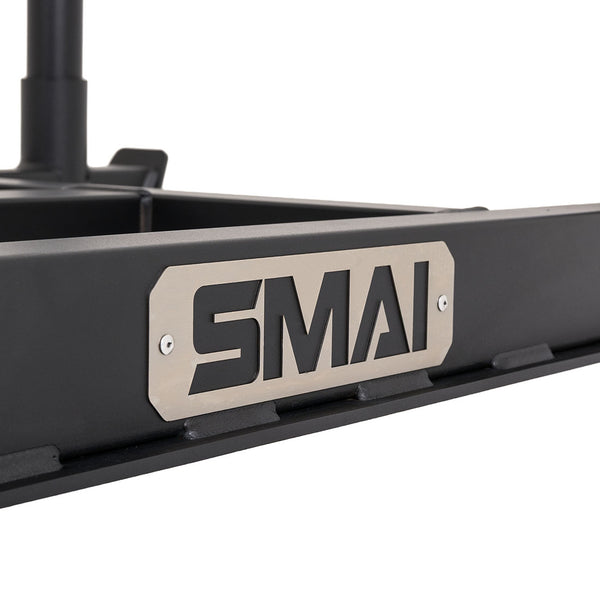 Close-up of the Tower Gym Sled - Hybrid Series frame, featuring a metal plate with the bold black “SMAI” logo. The plain background highlights the sled’s sturdy construction, making it ideal for intense workouts with gym sleds or hybrid training sleds.