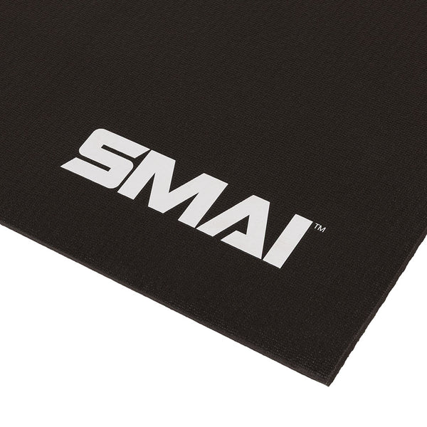 A close-up of the SMAI Exercise Mat - Extra Large (200cm x 122cm) in black, featuring the white “SMAI” logo printed in the corner.