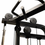 Close-up view of the SMAI Functional Trainer - FTS Slide gym machine photographed from a low angle, showcasing pulleys, cables, and a pull-up bar attachment. The dual weight stacks accentuate its versatile functional training capabilities.