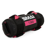 The SMAI Core Bag, in black and pink with "SMAI 7.5KG" label, features rip-proof vinyl and multiple handles, making it durable fitness equipment for weight training and strength exercises.