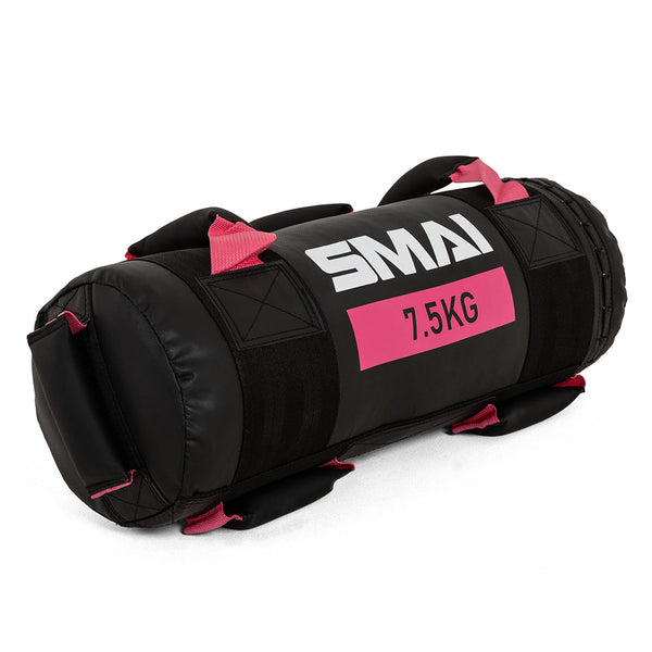 The SMAI Core Bag, in black and pink with "SMAI 7.5KG" label, features rip-proof vinyl and multiple handles, making it durable fitness equipment for weight training and strength exercises.