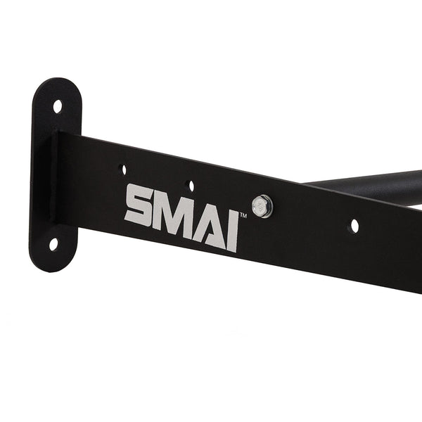SMAI Exercise Ball Storage Rack – Wall Mounted 150cm features a black metal bracket with "SMAI" printed in white, three holes and a bolt for mounting. Designed for efficient gym storage, this sturdy rack includes two mounting plates—one on the left and one extending backward—making it ideal for securely storing exercise balls in any fitness space.