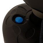 Close-up of the textured black circular base with a blue knob in the center from the SMAI Junior Punch Master - Black, set against a white background.