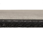 Close-up side view of the SMAI EPDM Rubber Gym Flooring Tile - 15mm - Black, highlighting its thick, rectangular shape with a smooth top surface and a textured, crumb-like layer underneath—an ideal example of premium gym flooring designed for superior durability and comfort.