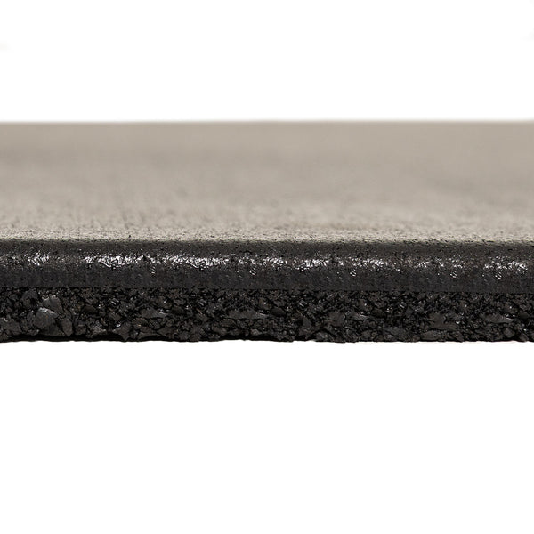 Close-up side view of the SMAI EPDM Rubber Gym Flooring Tile - 15mm - Black, highlighting its thick, rectangular shape with a smooth top surface and a textured, crumb-like layer underneath—an ideal example of premium gym flooring designed for superior durability and comfort.