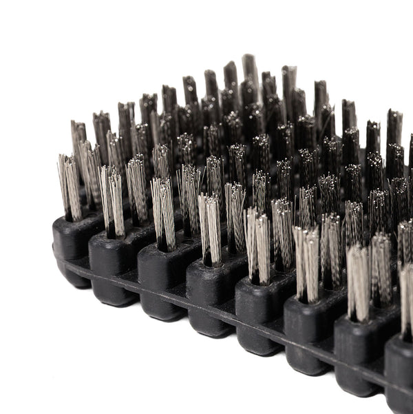 Close-up of the SMAI Barbell Cleaning Brush - Steel, a rectangular black brush featuring tightly packed, stiff steel bristles, photographed against a white background. Designed for barbell maintenance, this brush efficiently removes chalk and grime from lifting equipment.