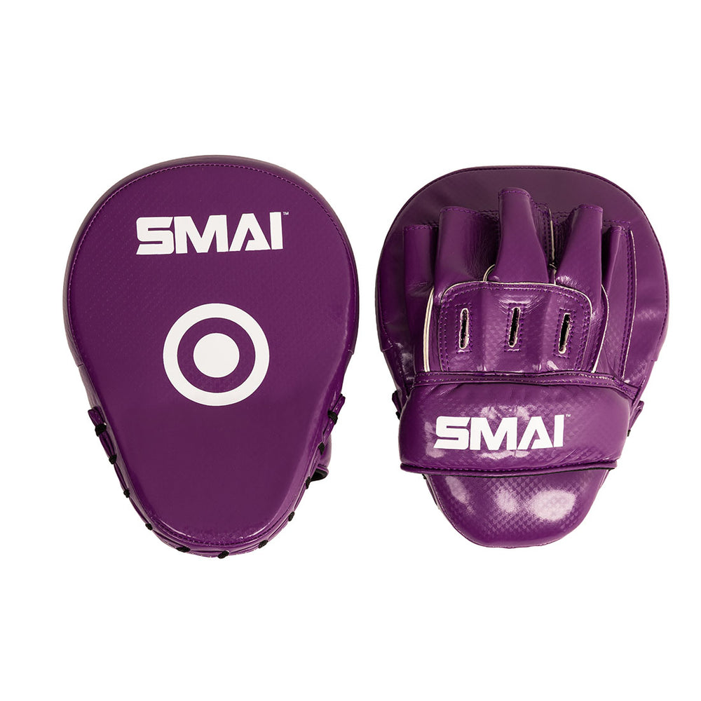 Two purple Essentials Boxing Mitts by SMAI are shown: one displays the front with a white target circle, while the other reveals the back featuring finger slots and a wrist strap—perfect as training focus pads or punching mitts for boxing sessions.