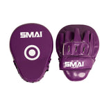 Two purple Essentials Boxing Mitts by SMAI are shown: one displays the front with a white target circle, while the other reveals the back featuring finger slots and a wrist strap—perfect as training focus pads or punching mitts for boxing sessions.