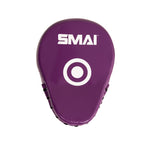 The SMAI Essentials Boxing Mitts - Purple feature a white target circle and logo on the front, making them ideal for martial arts training and perfect for enhancing accuracy and precision in your workouts.