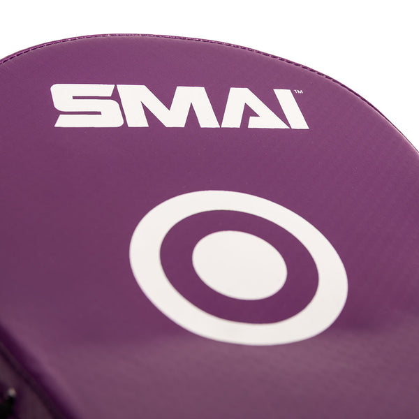 Close-up of the SMAI Essentials Boxing Mitts in purple, featuring a white target circle and the brand name “SMAI” printed on them.