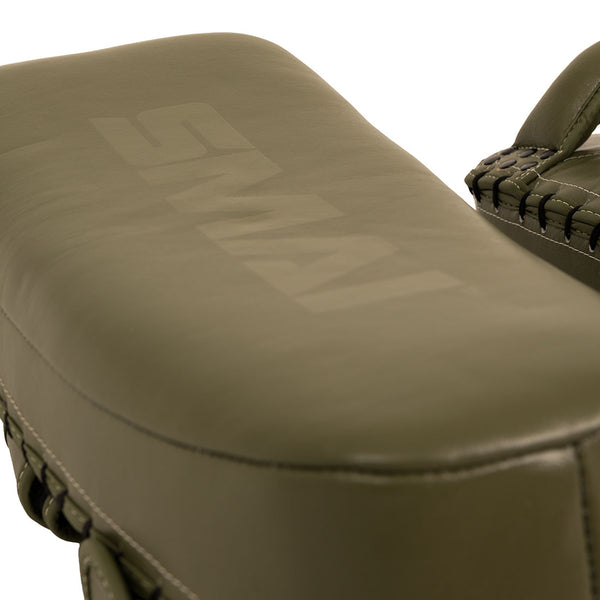 A close-up of the SMAI Thai Arm Pads V2 (Pair) in olive green, expertly crafted from high-grade leather with stitched edges and a subtle “SMAI” logo on the surface. These Muay Thai arm pads feature layered foam for superior protection and lasting durability.