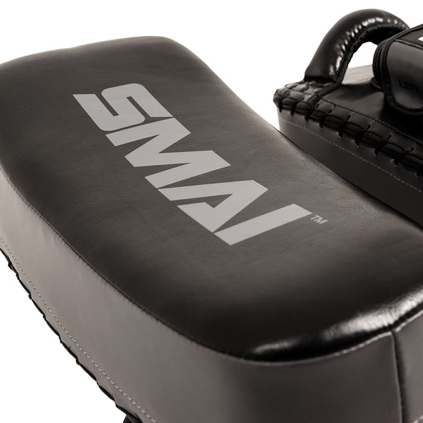 Close-up of a pair of grey Essentials Muay Thai Pads (Economy Pair) by SMAI, featuring durable synthetic leather construction with the “SMAI” logo in white—ideal for intense kickboxing and Muay Thai training.