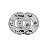 Two SMAI Calibrated Steel Change Plates, each weighing 0.25 KG, are shown overlapping on a white background. These silver steel plates feature two small holes along with a large central opening.