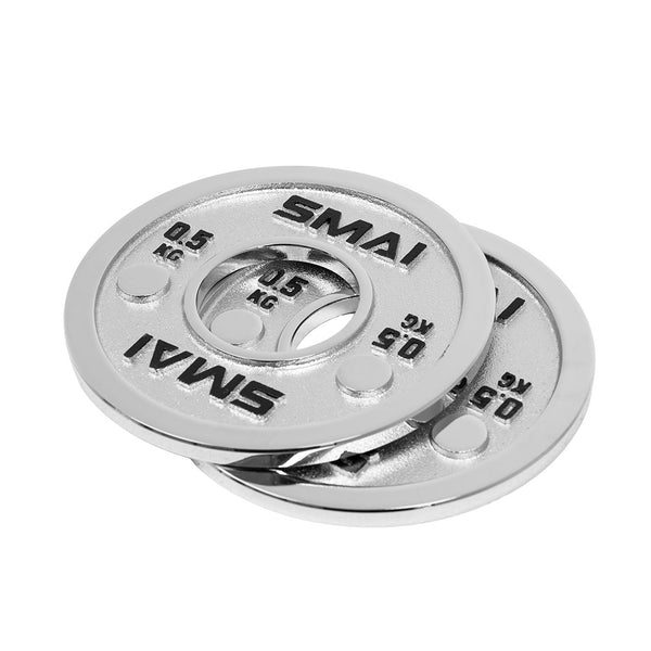 Two shiny silver Calibrated Steel Change Plates by SMAI, each weighing 0.5 kg and engraved with the “SMAI” logo, are stacked with a slight overlap on a white background.