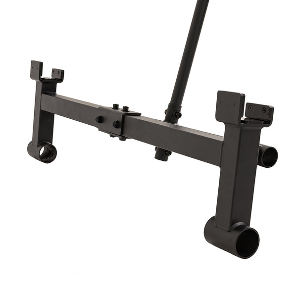 The SMAI Barbell Jack - Double is a black metal hitch attachment featuring both rectangular and cylindrical components, specifically designed for connecting to vehicles or equipment. Its mounting points and central connecting bar are reminiscent of mechanisms found on deadlift jacks, offering functionality similar to a barbell jack. The product is displayed against a plain white background.
