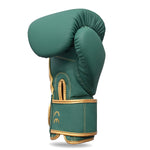 The SMAI Gold Series Boxing Glove in Green/Gold stands upright against a white background, showcasing its superior wrist support and shock absorption.