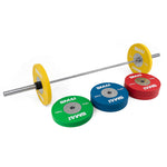 A SMAI Competition Bumper Plate Set with Barbell - 140kg is assembled, featuring yellow plates on the barbell. Nearby, the green, blue, and red plates from the set are ready on the floor for an Olympic weightlifting session.