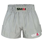 Grey SMAI Muay Thai Shorts - Grey satin polyester with an elastic waistband and brand logos on the front center and lower leg.
