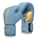 A pair of SMAI Gold Series Boxing Gloves in light blue with gold accents features black velcro straps for enhanced wrist support and displays the “SMAI” brand name in gold on both the wrist and top. One glove is positioned upright while the other is tilted forward.