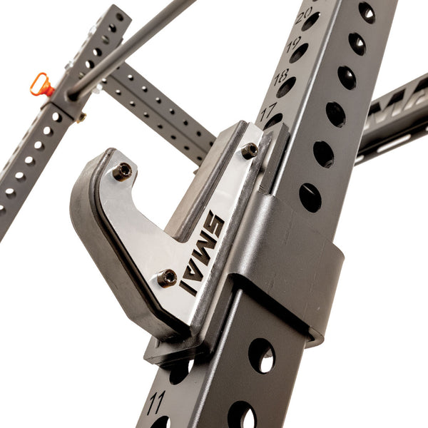 Close-up of the SMAI Folding Wall Mounted Squat Rack, showcasing its numbered holes and sturdy J-hook for securely holding a barbell. This rack is ideal for maximizing space in your garage gym while delivering dependable support throughout your workouts.