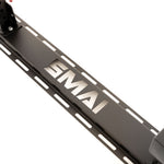 A close-up of a black metal component from the SMAI Folding Wall Mounted Squat Rack, featuring the "SMAI" brand name cut out in the center and elongated slots on either side—perfect for adding to your garage gym setup.