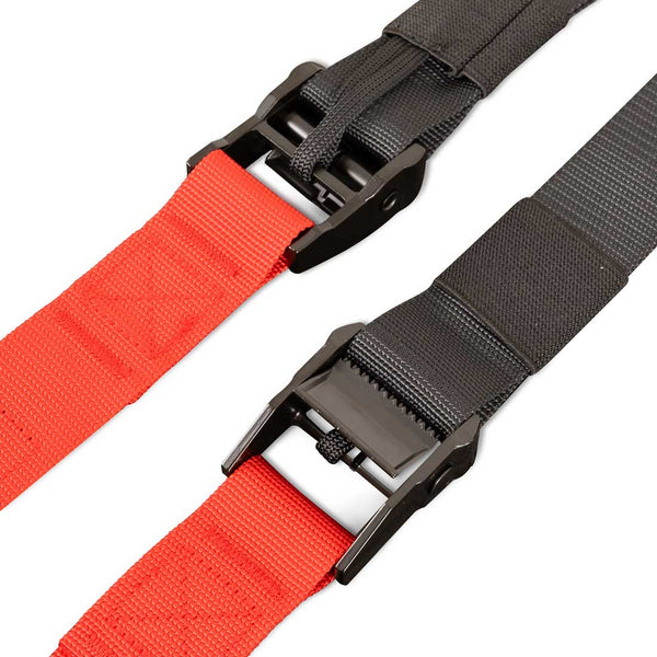 Close-up of two heavy-duty adjustable straps with metal buckles, one red and one black, lying parallel on a white background—essential components of the SMAI Suspension Trainer - GTS, a portable fitness equipment set designed for gravity training systems and bodyweight workout routines.