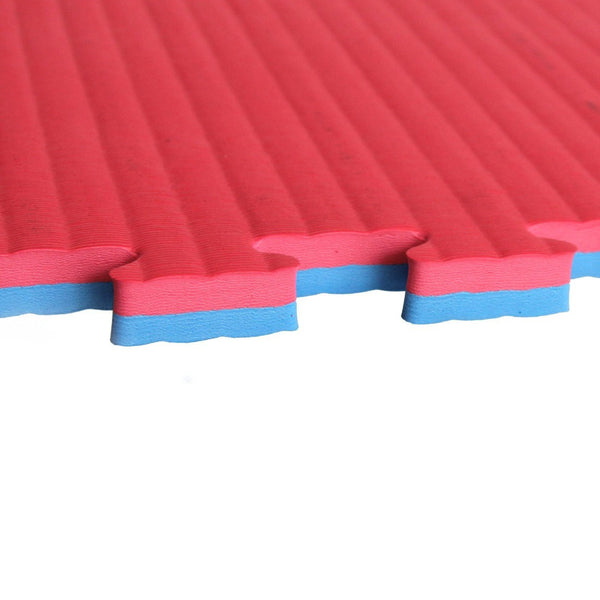 Close-up of the SMAI Jigsaw EVA Mat Premium Range - 3cm, showing its red textured surface, blue middle layer, and puzzle-like edge against a white background—perfect for EVA safety flooring.