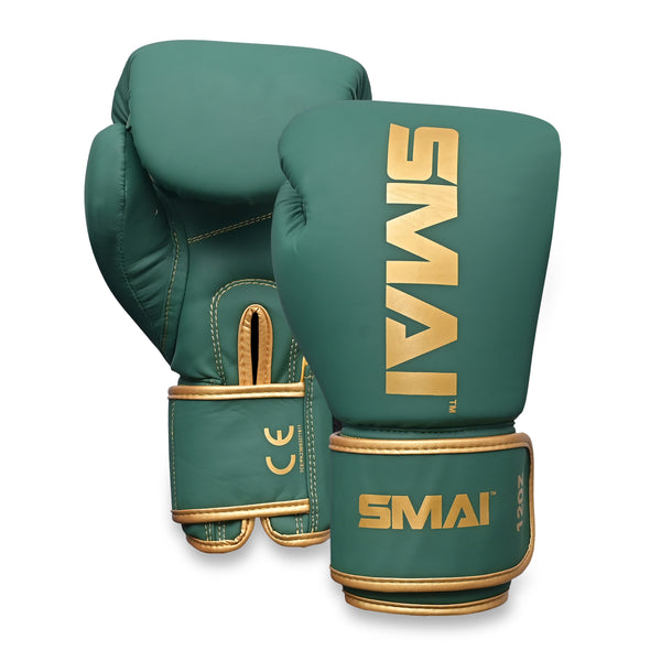 The SMAI Gold Series Boxing Glove in Green/Gold features gold trim and the SMAI logo in gold on the wrist and back of one glove. Designed for superior wrist support and enhanced shock protection, this pair is displayed against a white background.