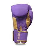 The SMAI Gold Series Boxing Glove - Purple/Gold is displayed upright with the thumb facing right, showcasing "GOLD" printed on the wrist strap and enhanced wrist support for improved comfort and stability.