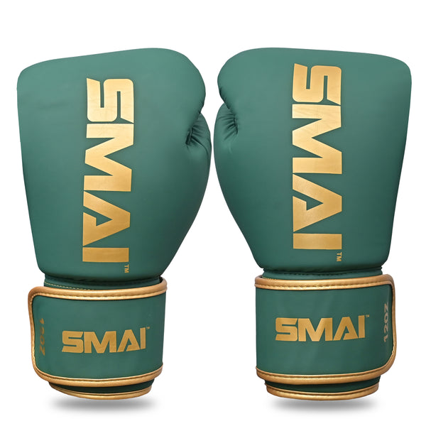 A pair of SMAI Gold Series Boxing Gloves in green and gold, featuring the brand name "SMAI" in gold lettering on the front and wrist straps, are designed for enhanced wrist support and superior shock protection, shown upright side by side against a white background.
