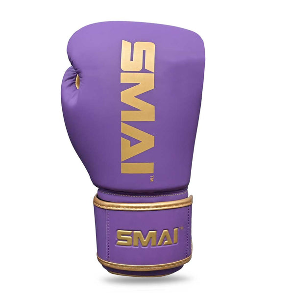 The Gold Series Boxing Glove - Purple/Gold by SMAI is shown against a white background, featuring a single purple glove with gold accents and "SMAI" printed in gold on both the top and wrist strap, designed for exceptional wrist support.