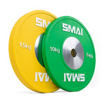 Two weight plates are displayed standing upright. One is yellow featuring "15 kg" and the other is green marked with "10 kg," both prominently displaying the SMAI brand and having a metal center. Designed for Olympic weightlifting, these competition bumper plates from the SMAI Competition Bumper Plate Set with Barbell - 50kg integrate seamlessly with any barbell setup.