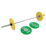 The SMAI Competition Bumper Plate Set with Barbell - 50kg is showcased on a white background, featuring large yellow weights on both ends ideal for Olympic weightlifting. Two extra green competition bumper plates are positioned beside the bar on the floor, each clearly marked with "SMAI" and their respective weights.