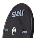Close-up of a 5 kg weight plate from the HD Bumper Plates Set with the brand name "Sale Item" in gray letters, highlighting its commercial-grade quality. This high-quality gym equipment displays weight indications on both sides of the center hole, making it an ideal choice for those seeking durable rubber bumper plates.