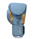 The SMAI Gold Series Boxing Glove in Light Blue/Gold features gold accents and "GOLD" printed near the wrist strap. Designed to deliver exceptional shock protection and wrist support, this glove is photographed against a white background.